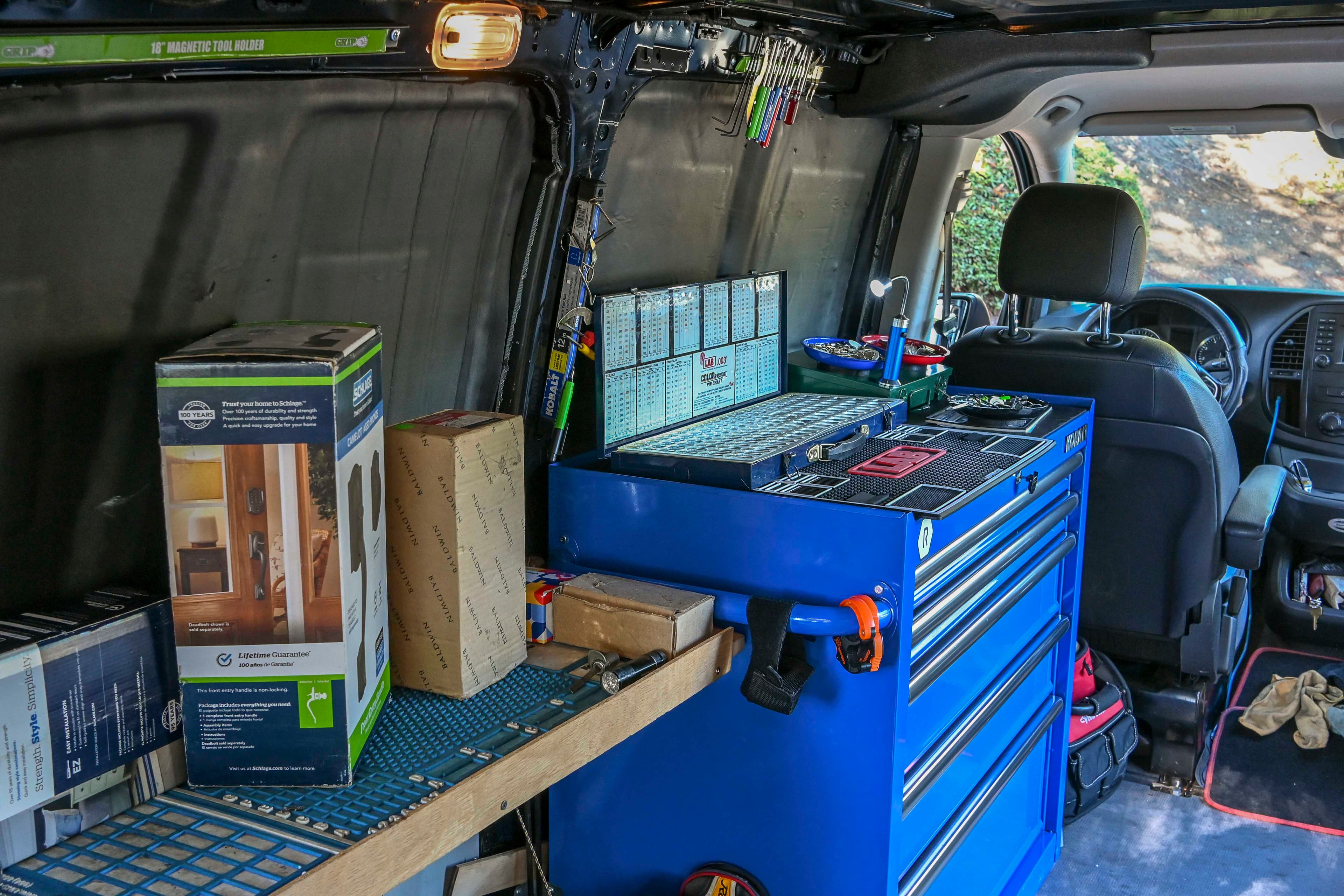 Locksmith tools and hardware organized in the van